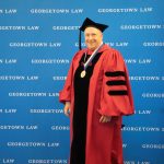 A man in red academic regalia