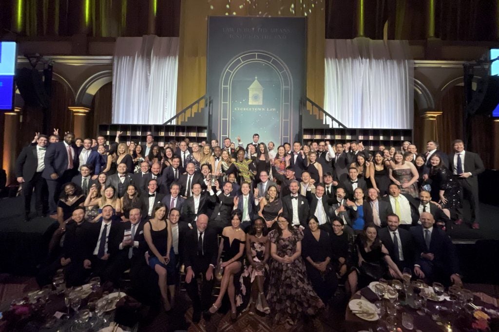 A stage overflowing with people at the Georgetown Law alumni gala