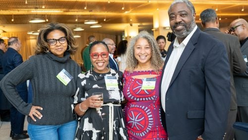 Three women and a man standing together