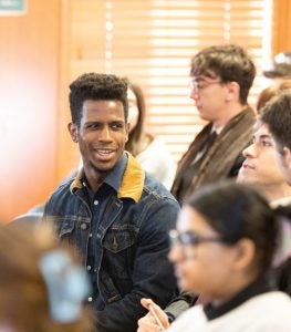 Student Marvin Clark sits in the audience. He asked Chair Khan about the FTC's stance on tech start-ups that pursue acquisition by larger companies.