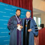 Prof. Anthony Cook poses with Dean Treanor at a Feb. 28 ceremony honoring five new named professors.