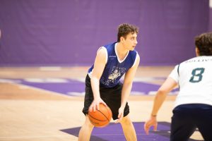 A basketball player mid-dribble