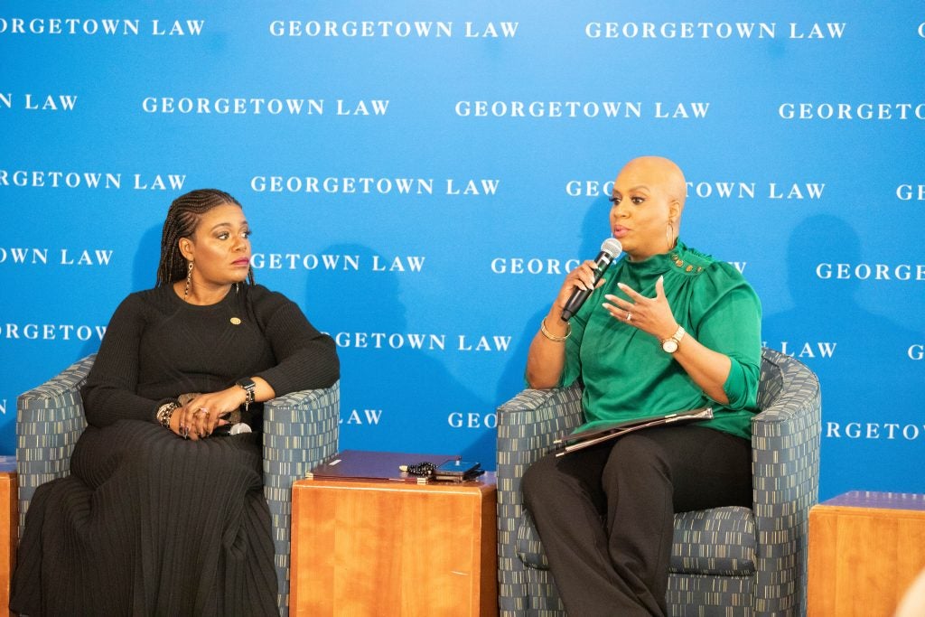 Two women speaking on a stage