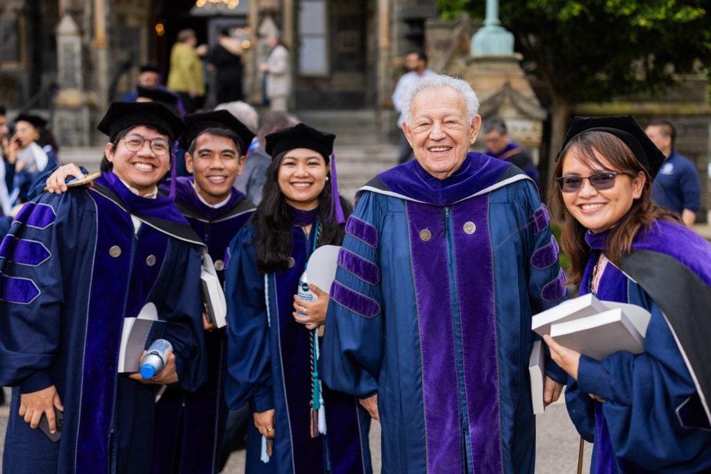 Honorary degree recipient Philip Hirschkop, L’64, H’24, poses for a photo with students.