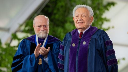 Dean William M. Treanor and honorary degree recipient Philip Hirschkop, L’64, H’24 on the commencement stage.