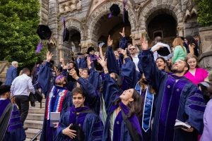 Class of 2024 graduates throw their caps in the air at Commencement. Photo credit: Elman Studio. 