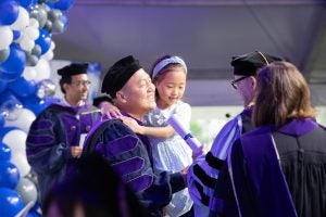 A graduate collects his diploma at a Celebration Days ceremony.