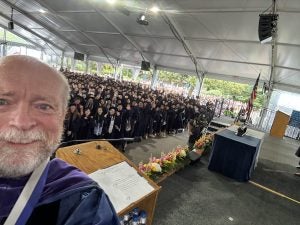 Dean William M. Treanor poses for a selfie with the audience following a Celebration Days ceremony.