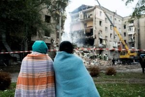Residents of Zaporizhzhia, Ukraine survey Russian airstrike damage to their apartment building.  Photo: Elena Tita/Collection of war.ukraine.ua