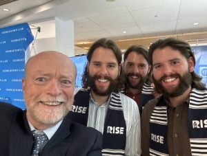 Dean William M. Treanor poses for a selfie with the brothers.