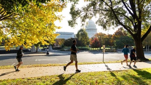 Runners pass the U.S. Capitol during the Hoya Lawya Fun Run.