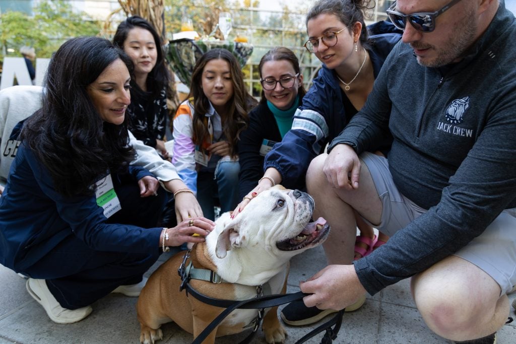 Alumni and guests gathered around Jack the Bulldog.