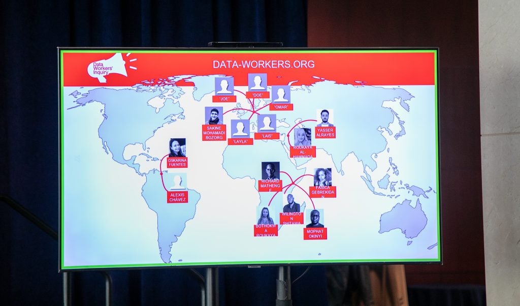 An informational screen displays a map of data workers at the Data Workers’ Inquiry workshop.