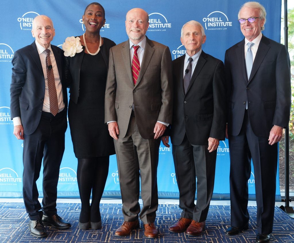 Profs. Lawrence Gostin and Michele Goodwin, Dean William M. Treanor, Dr. Anthony Fauci and Timothy J. O’Neill pose for a group photo.