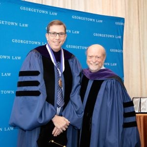 Prof. Stephen I. Vladeck poses for a photo with Dean Treanor