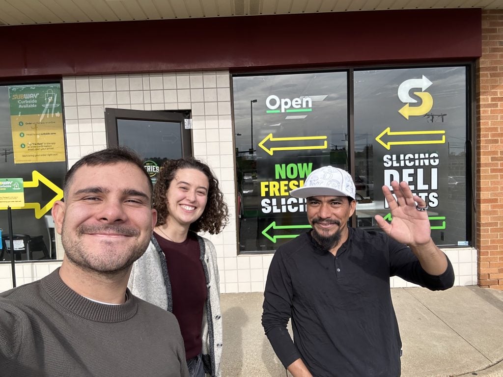 Rodrigo Bermudez and Madeline Sachs pose for a photo with their client.