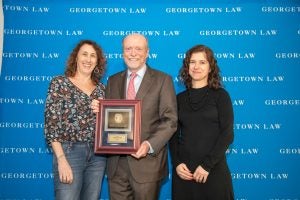  Dean William M. Treanor (center) and Associate Dean for Academic Affairs Professor Urska Velikonja (right) present Professor Deborah Epstein (left) with the 2025 Frank F. Flegal Excellence in Teaching Award.
