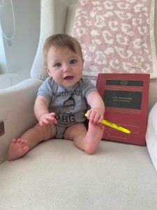 Levin-Epstein's daughter, Amelia, is seated next to a law textbook. The two are nearly the same size.
