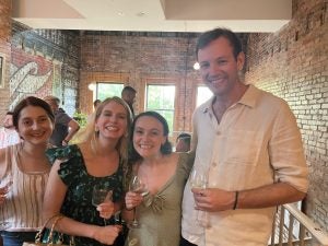Opinsky poses for a photo with friends at a recent birthday celebration.