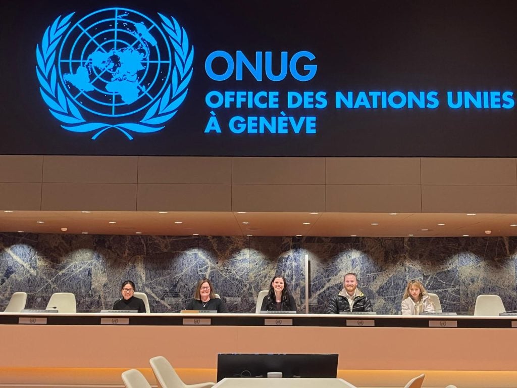 A group of people sitting in chairs at a United Nations facility in Geneva