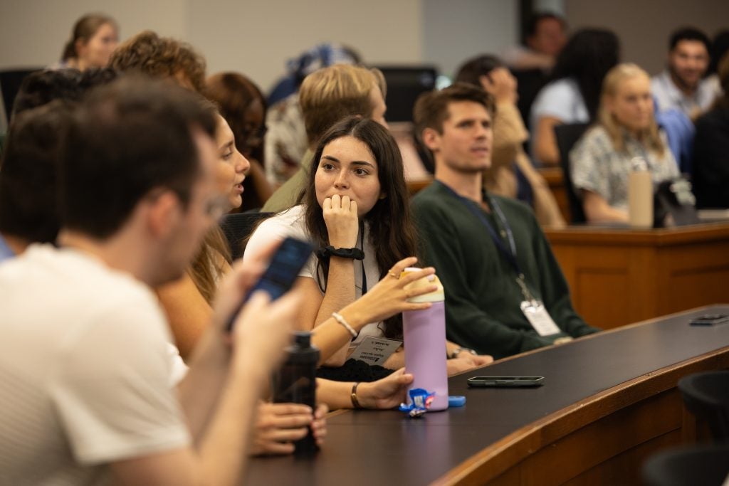 Students engaged in conversation in a Georgetown Law classroom