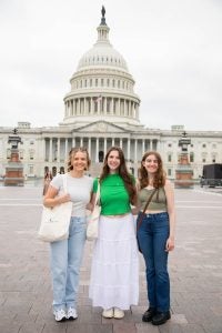Three women standing in front of the U.S. Capitol