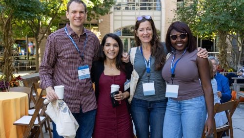 Alumni pose for a group photo at the 2025 reunion picnic