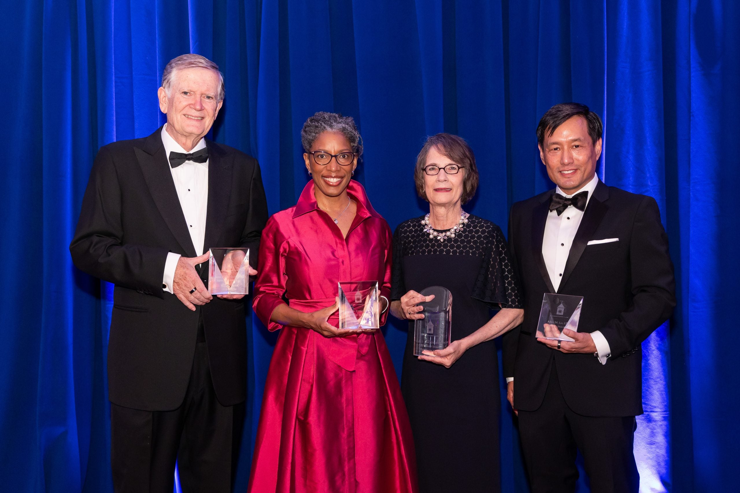 Recipients of the 2025 Alumni Awards pose with their awards.