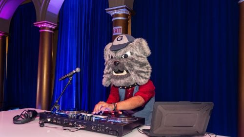 The Reunion Gala DJ wearing the head of the Jack the Bulldog mascot costume.