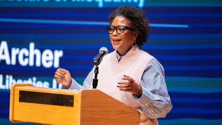 Deborah Archer standing at podium in Hart Auditorium.