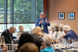 A guest stands to share a story at the Founders' Circle Luncheon.