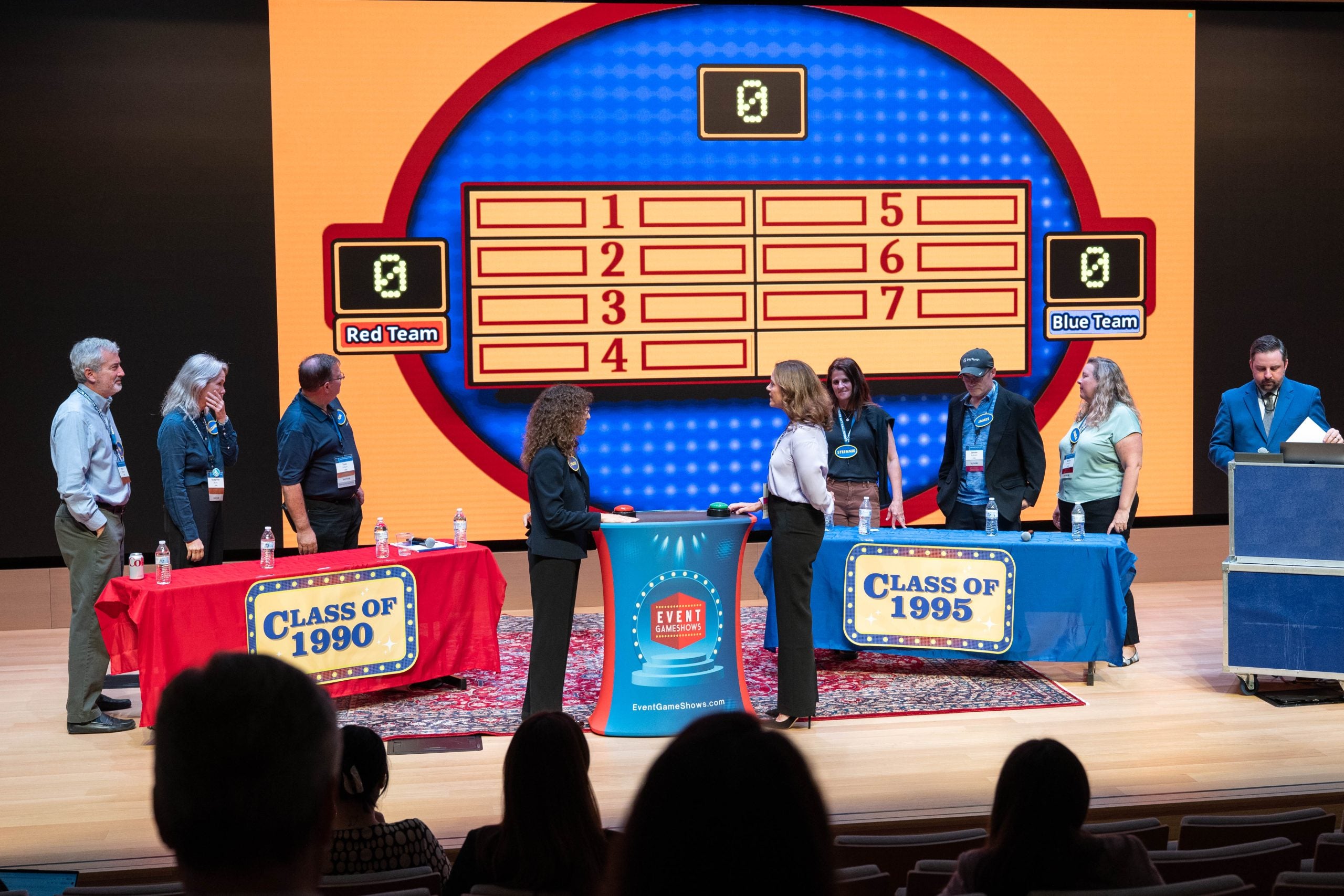 Survey game players stand at the podium to compete.