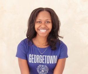 Belle Minter Noralez smiles while wearing a Georgetown t-shirt.