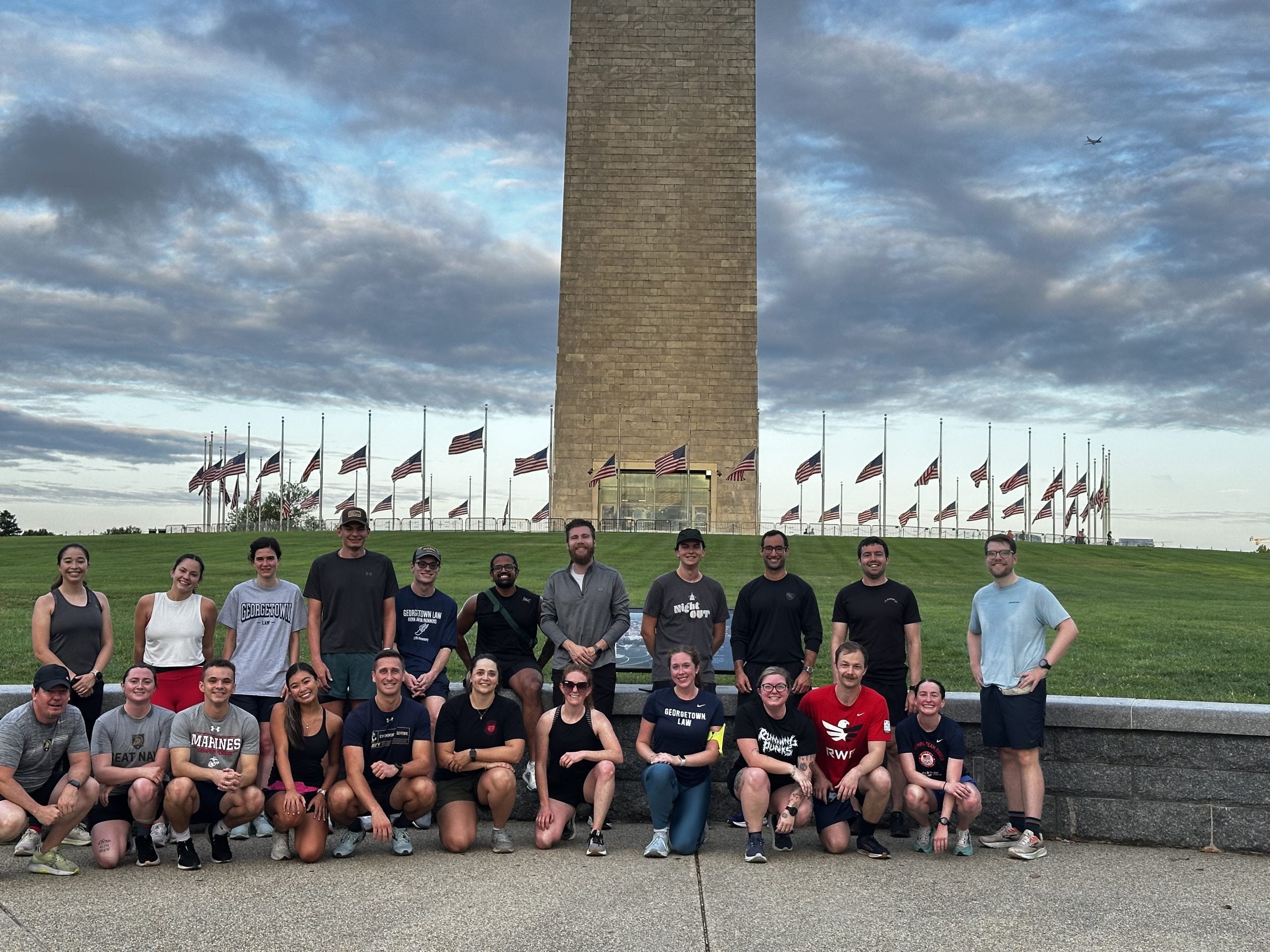 Students pose in front of the Washington Monument after a group run.