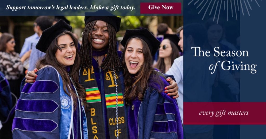 Three students smiling at commencement with the text The Season of Giving on the picture