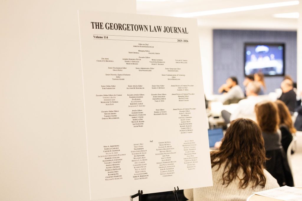 A poster with the masthead of the Georgetown Law Journal, photographed in the doorway of a symposium event