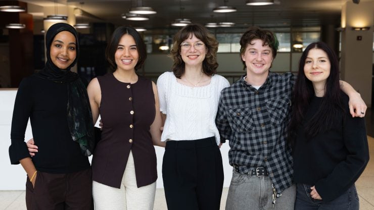 Pictured, Five current Georgetown Law students posing for a photo, Susan Aboeid, L'27, Ashley Nies, L'27, Claire Ellis, L'27, Molly Izer, L'27, and Mikaylah Ladue, L'27, are the first to receive scholarships for the fund established by Amb. Alfred Moses, L'56, H'13, to support students and recent graduates pursuing careers in public interest law.