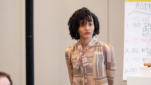 An instructor stands in front of a class.