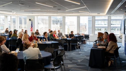 Attendees sit at tables and listen to panelists at the 2026 Dash Conference.