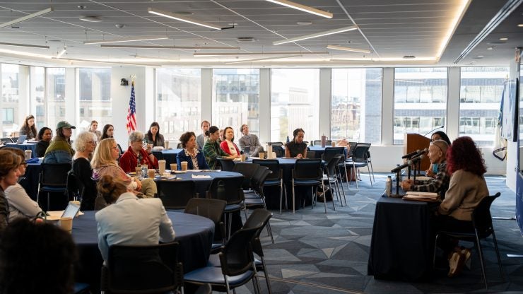 Attendees sit at tables and listen to panelists at the 2026 Dash Conference.