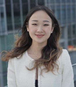 Headshot of Bingyang, smiling, wearing a white jacket and smiling
