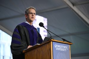 Prof. David Cole stands and speaks at a podium.