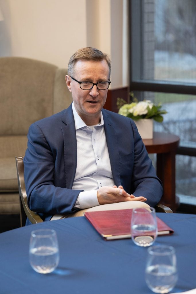 A man sitting at a table and speaking