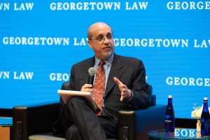 Michael Rosenberg holds a mic and addresses the audience during a March 10 panel event