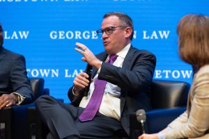 Justin Wyatt holds a mic and addresses the audience during a March 10 panel event