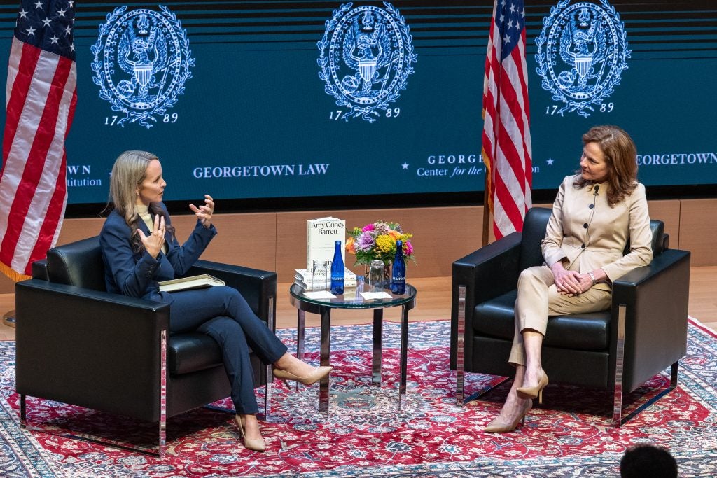 Stephanie Barclay and U.S. Supreme Court Justice Amy Coney Barrett sit onstage in Hart Auditorium for a fireside chat.