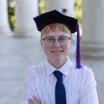 A young person wearing an academic beret