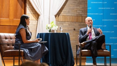 Two people in dialogue on a stage