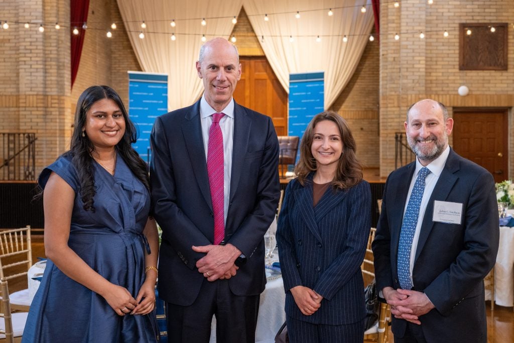 Four people standing together at the Georgetown Law Journal banquet