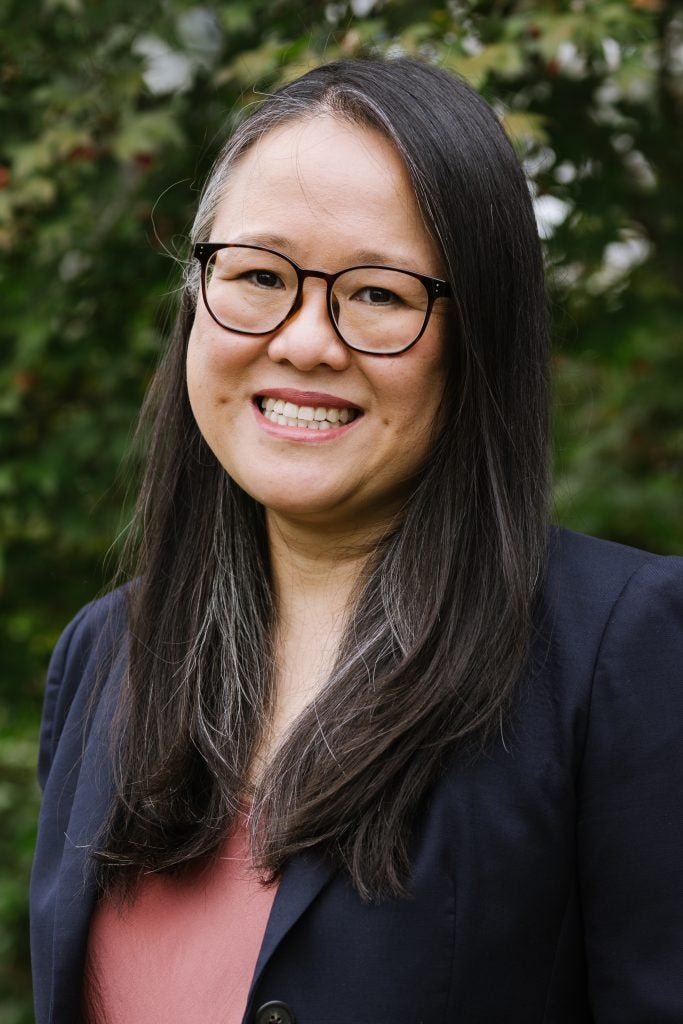 A woman with long hair, wearing glasses